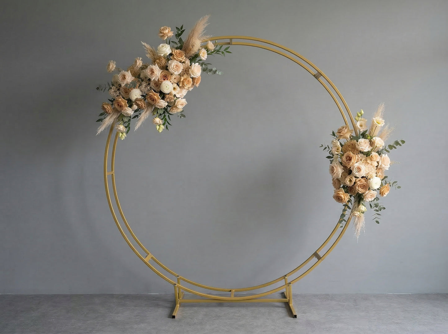 Gold circular arch with floral decorations on a gray background