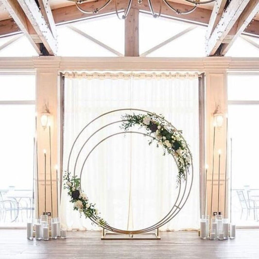 triple circles metal wedding arch decorated with flowers 